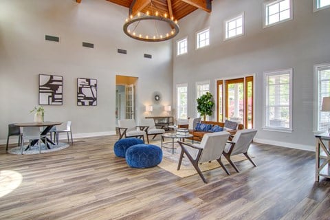 a living room with a couch and chairs and a dining room table